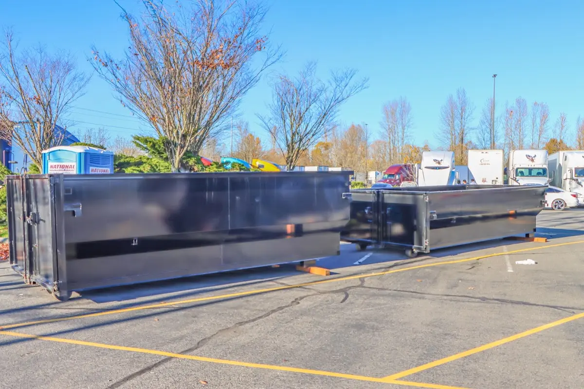 Professional dumpster rental service with roll-off container on residential driveway in Edmond